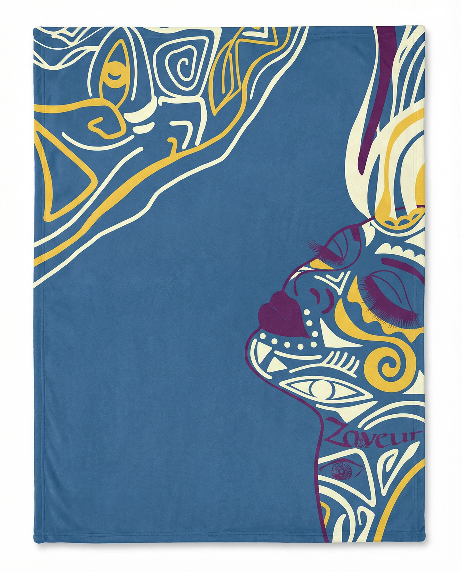 Person sitting by the beach wrapped in a blue and yellow abstract art fleece blanket, showcasing a calm mindful lifestyle and soft premium fabric