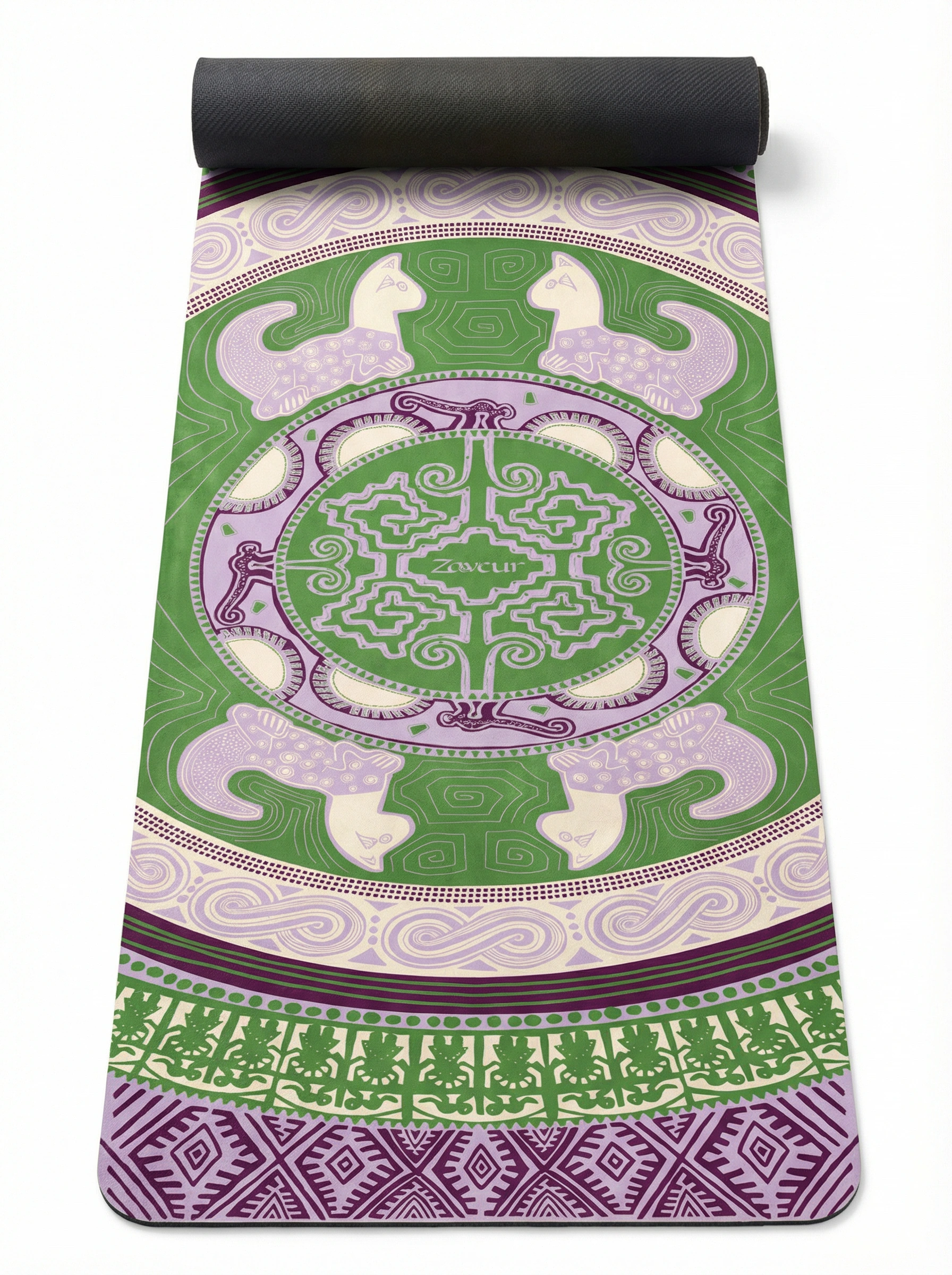 Full view of unrolled yoga mat in green and purple colorway displaying symmetrical mandala design with Zaveur branding, peacock figures, spiral waves, and decorative tribal borders with black backing