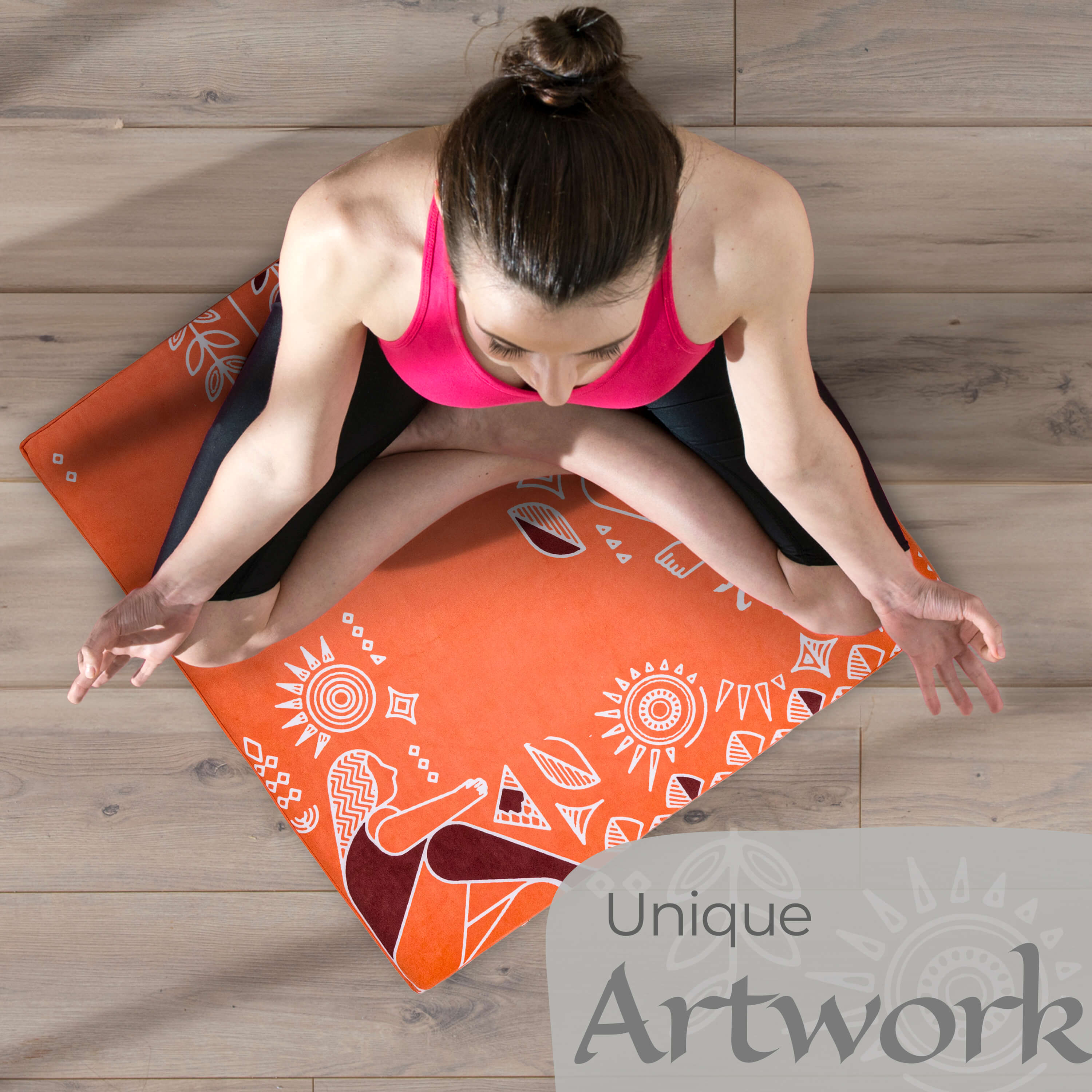 Woman practicing yoga on an orange mat with white patterns on a wooden floor.
