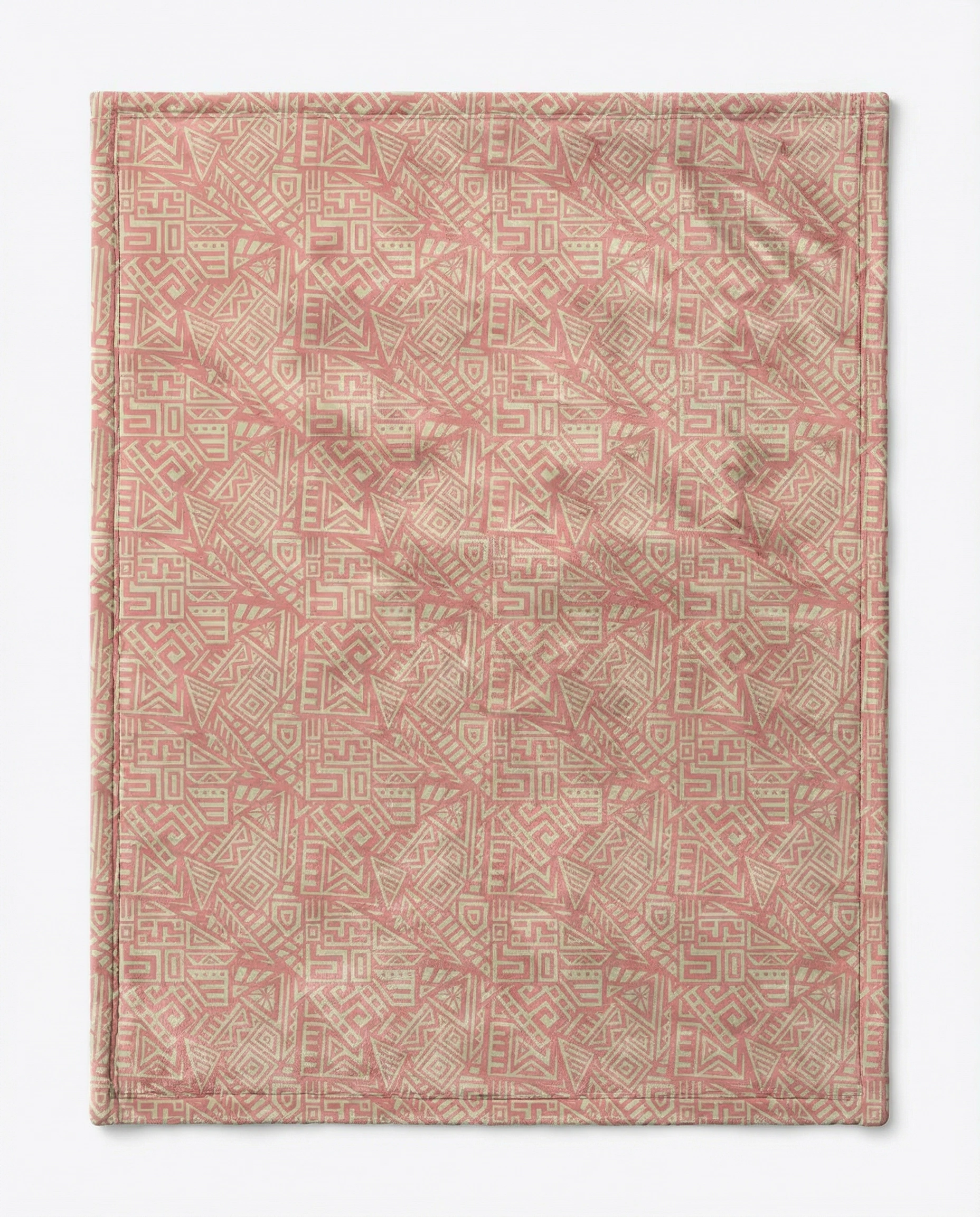 Flat lay of a pink yoga towel featuring an all-over geometric tribal pattern, showcasing a boho-inspired mindful living and meditation design.
