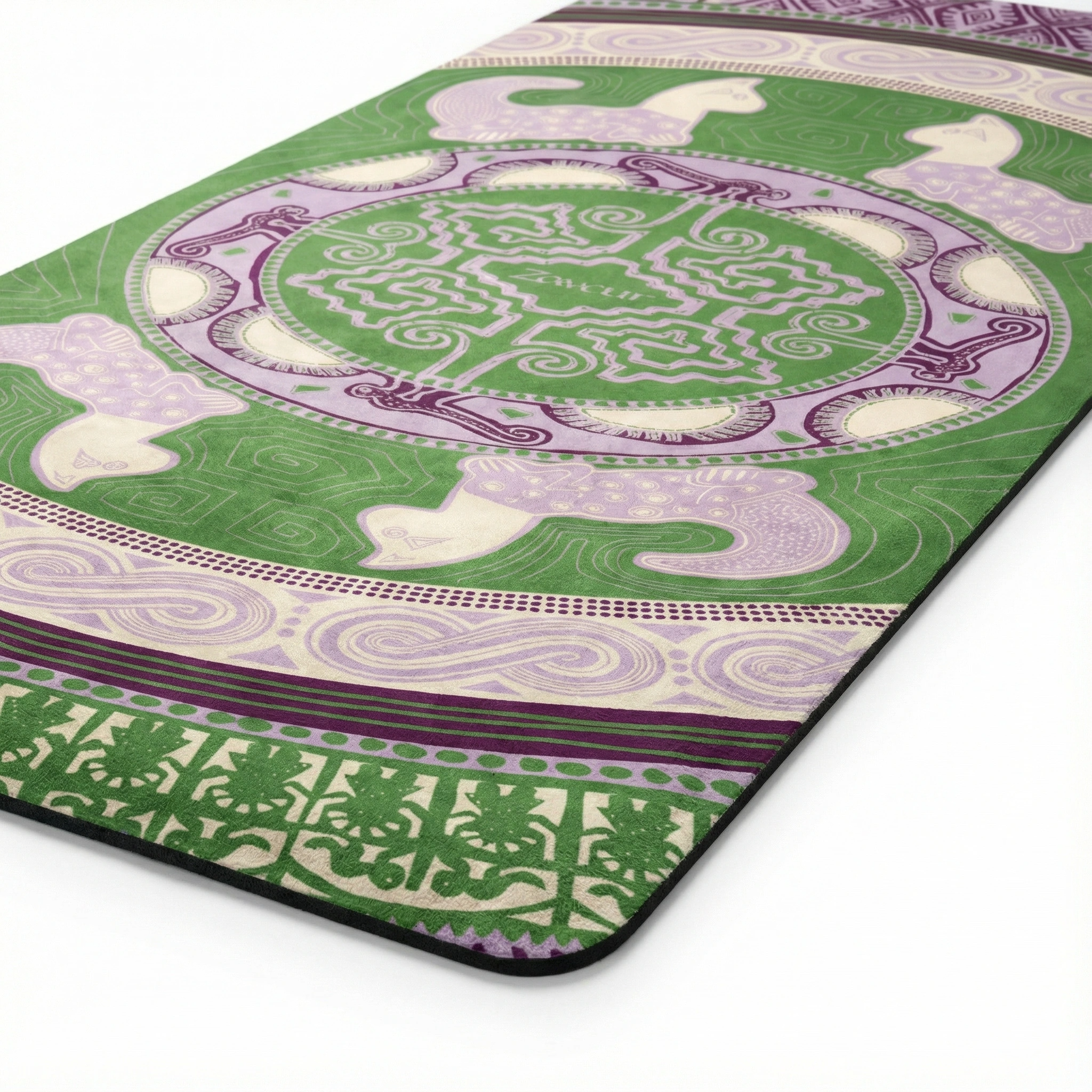Corner detail of yoga mat featuring green and lavender mandala medallion with geometric patterns, peacock birds, spiral borders, and tribal design elements