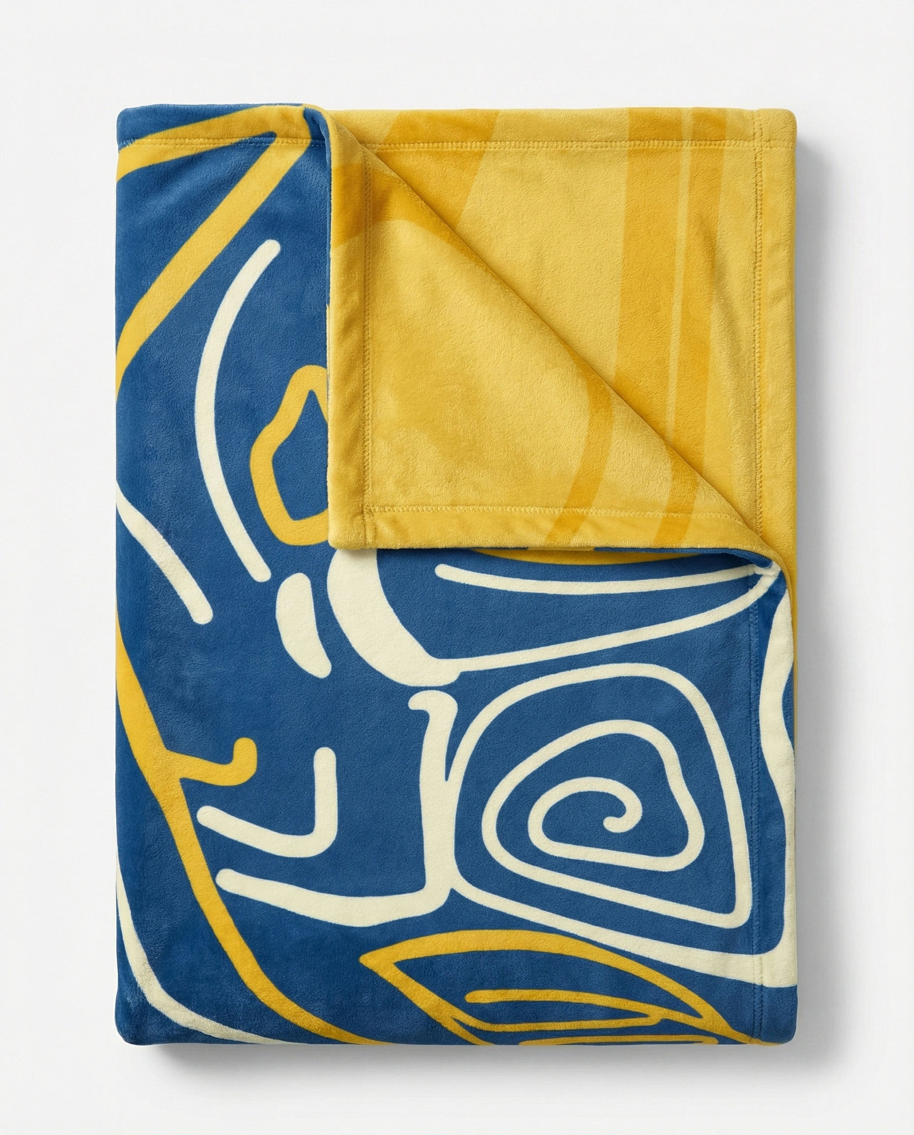Folded reversible fleece blanket showing a blue abstract art front and a yellow patterned reverse side, highlighting plush fabric and premium craftsmanship
