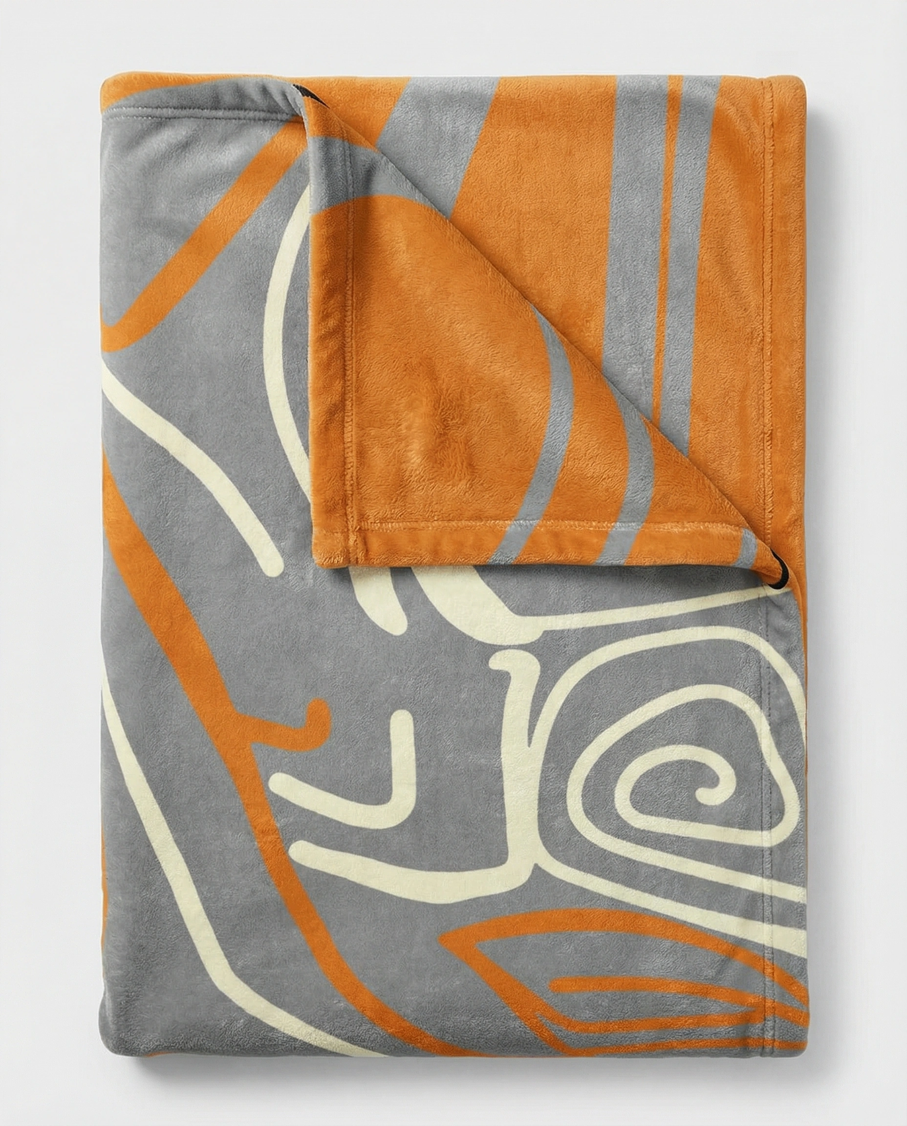 Folded reversible fleece blanket showing a soft gray abstract art side and a warm orange reverse, highlighting plush fabric and premium craftsmanship