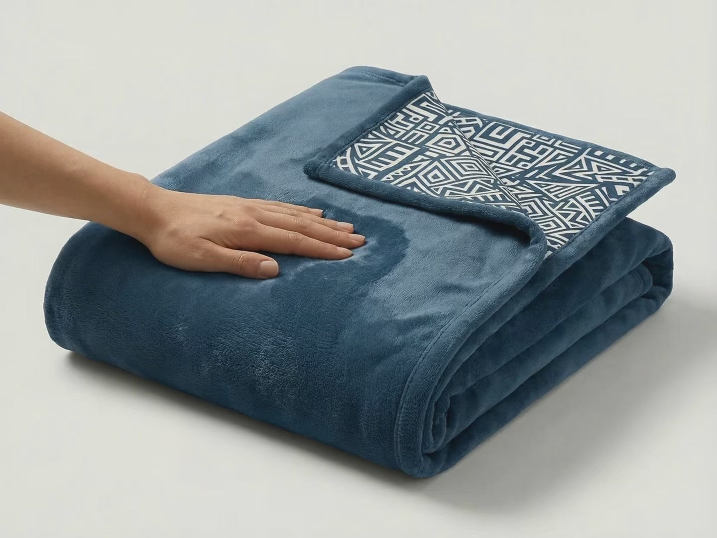 Product showcase video of a reversible pink fleece blanket featuring African tribal dancers artwork, highlighting soft texture, vibrant colors, and detailed design