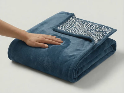 Product showcase video of a reversible pink fleece blanket featuring African tribal dancers artwork, highlighting soft texture, vibrant colors, and detailed design